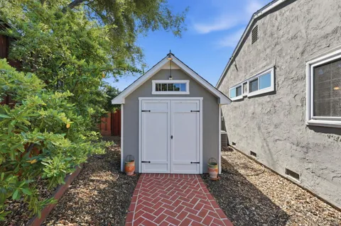 a lawn chairs sitting in a backyard of a house