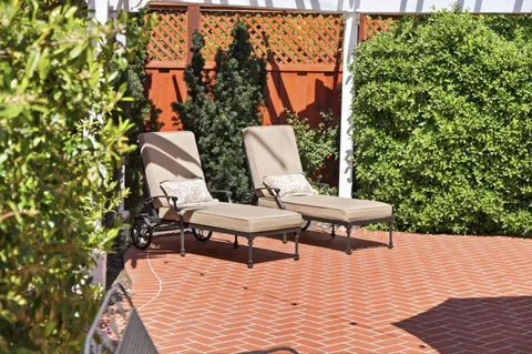 a view of a chairs and fire pit in the garden