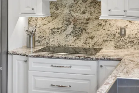 a view of granite countertop white cabinets and a granite counter tops