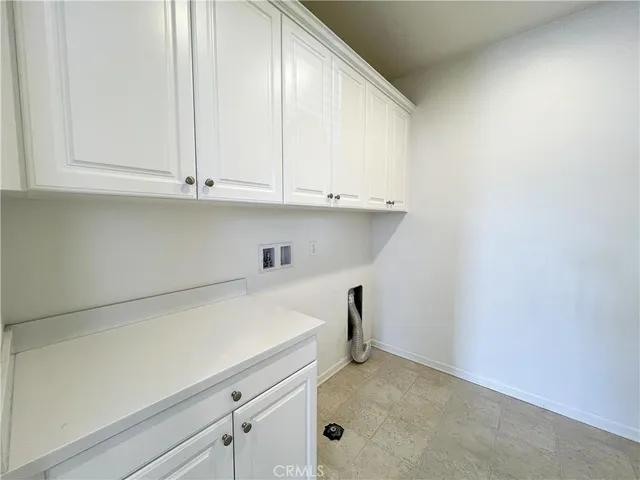 a view of kitchen with white cabinets
