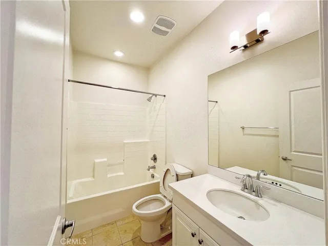 a bathroom with a sink mirror toilet and bathtub