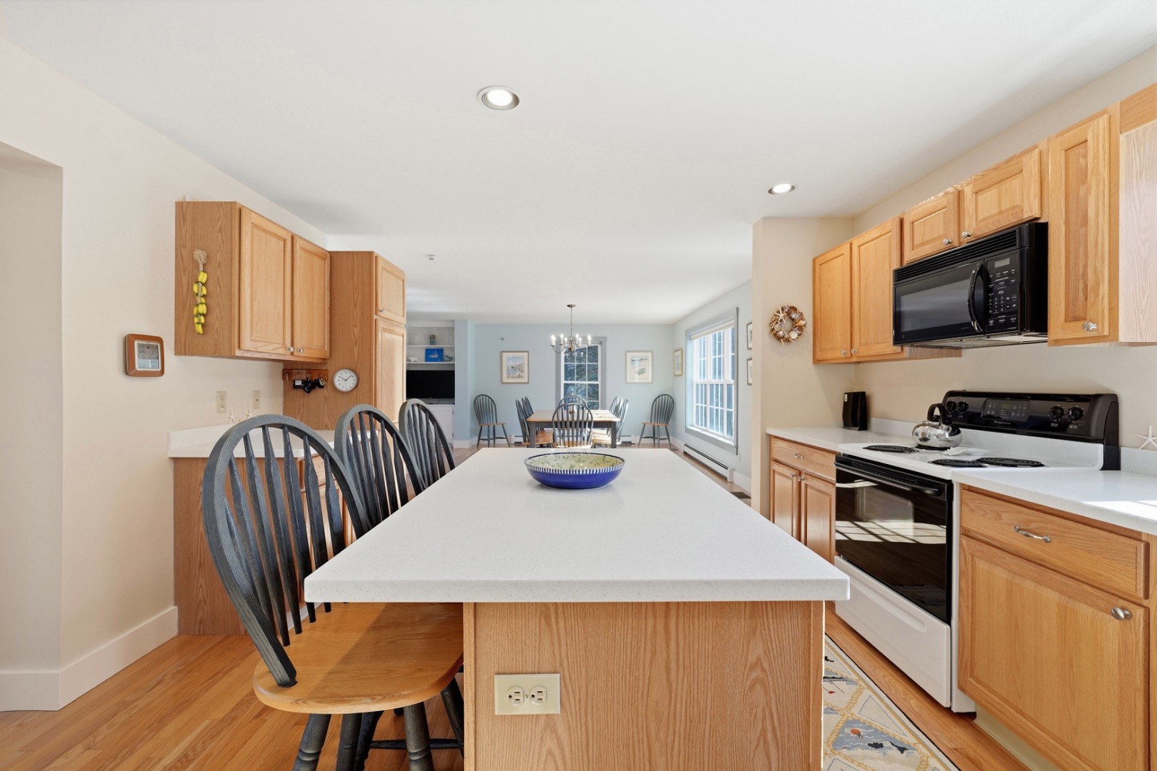 20 Rudder Lane Nantucket, MA 02554 - Photo 17 of 34 a kitchen with a table chairs stove and microwave