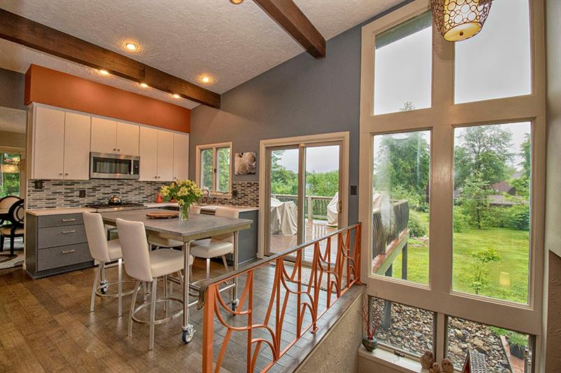 117 Foxglove Road Baden, PA 15005 - Photo 14 of 25 Floor to ceiling windows light the kitchen, where you will find more deck access.