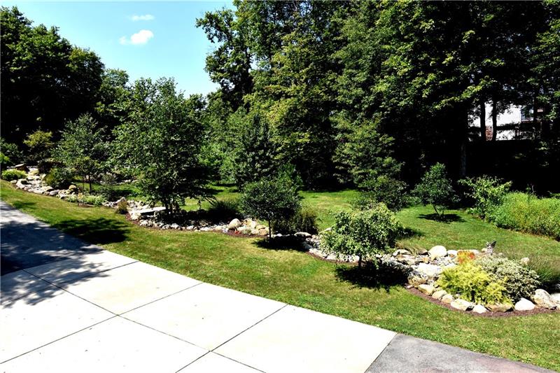 117 Foxglove Road Baden, PA 15005 - Photo 7 of 25 The dry creek bed lines the entire length of the driveway!