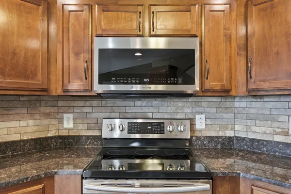 a stove top oven sitting inside of a kitchen
