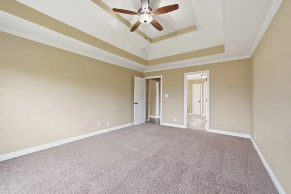 a view of an empty room and a ceiling fan
