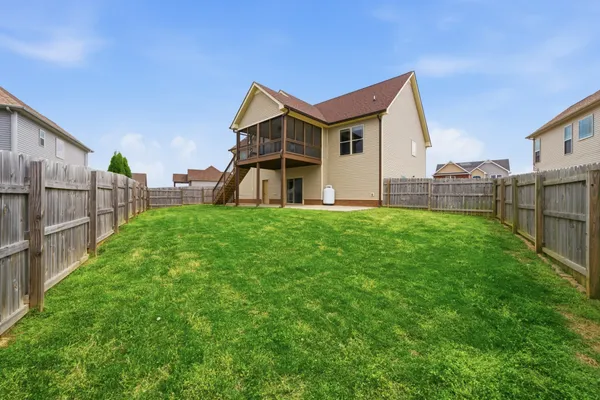 a view of a house with a yard and sitting area