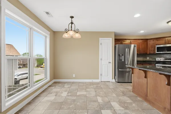 a view of a kitchen with a sink and refrigerator