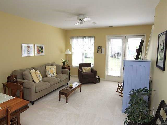106 Higher Learning Drive Durham, NC 27713 - Photo 2 of 15 Spacious living room has a ceiling fan and leads ou to the patio. Living Room