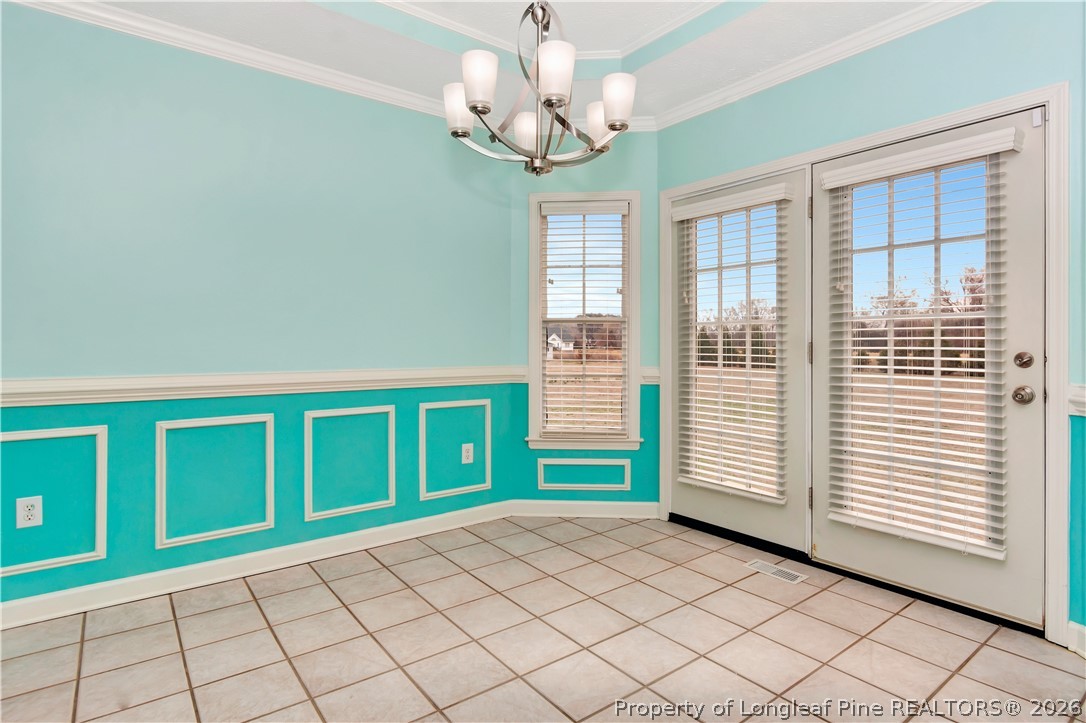 143 Pridgen Road Lumberton, NC 28358 - Photo 11 of 37 a view of an room with a chandelier fan and windows