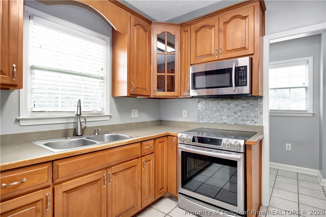 143 Pridgen Road Lumberton, NC 28358 - Photo 14 of 37 a kitchen with stainless steel appliances granite countertop a stove microwave and sink