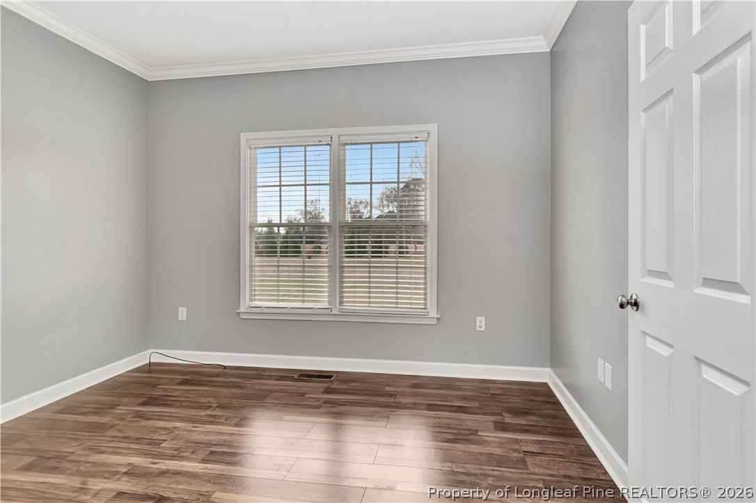 143 Pridgen Road Lumberton, NC 28358 - Photo 18 of 37 a view of an empty room with wooden floor and a window