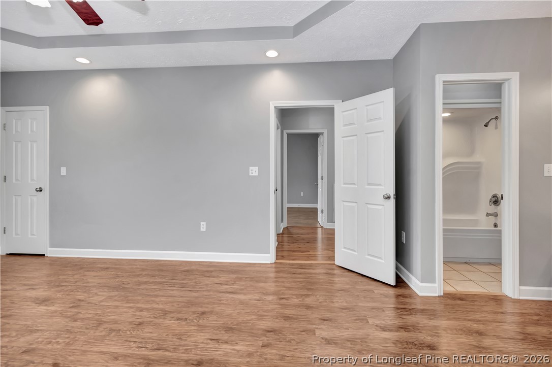 143 Pridgen Road Lumberton, NC 28358 - Photo 23 of 37 wooden floor in an empty room with a bathroom