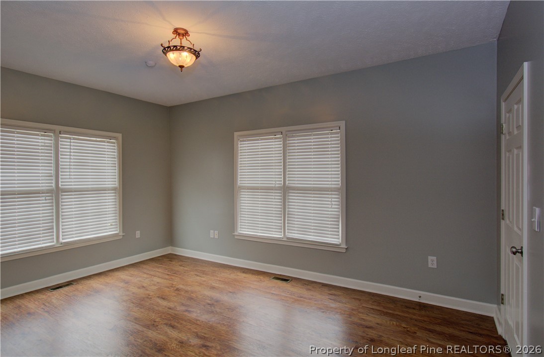 143 Pridgen Road Lumberton, NC 28358 - Photo 26 of 37 an empty room with windows and chandelier fan
