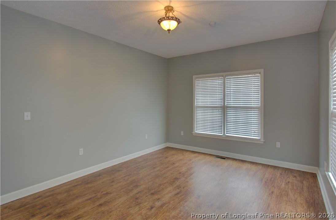 143 Pridgen Road Lumberton, NC 28358 - Photo 27 of 37 wooden floor in an empty room with a window