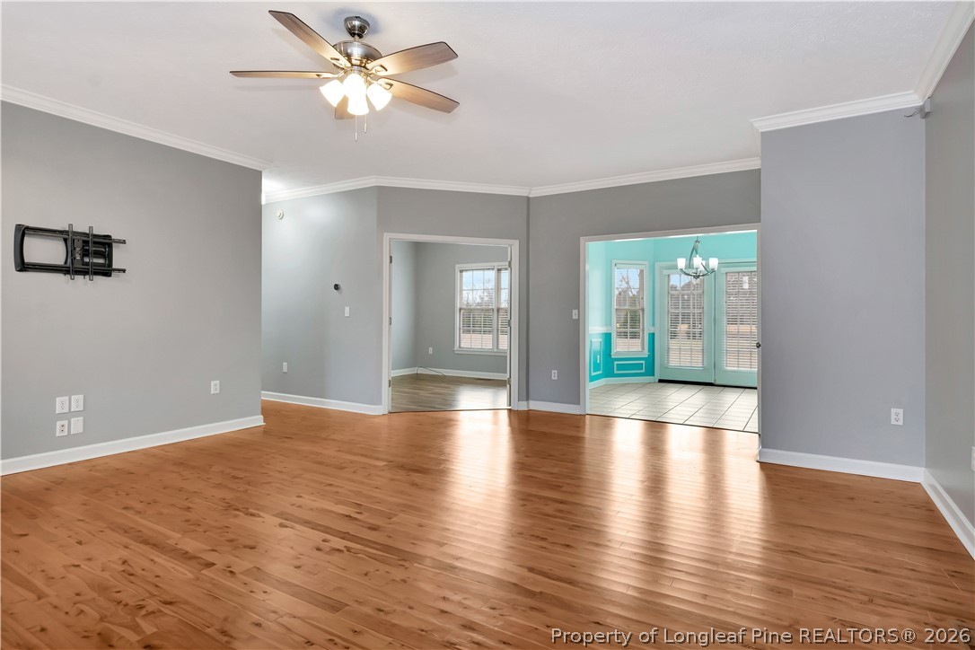 143 Pridgen Road Lumberton, NC 28358 - Photo 6 of 37 a view of an empty room with window and wooden floor