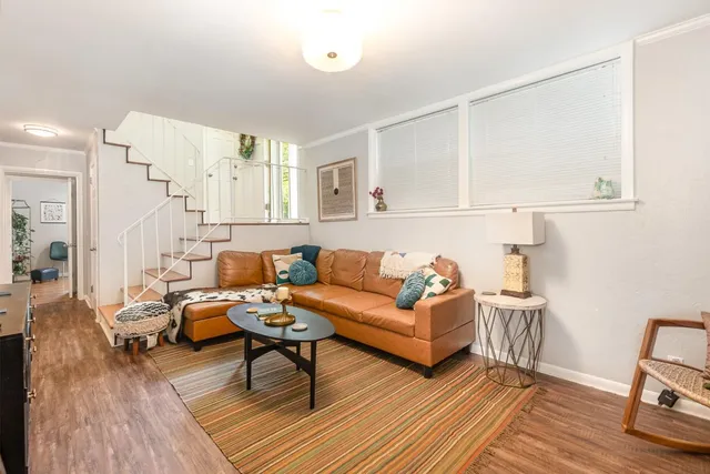 a living room with furniture and wooden floor