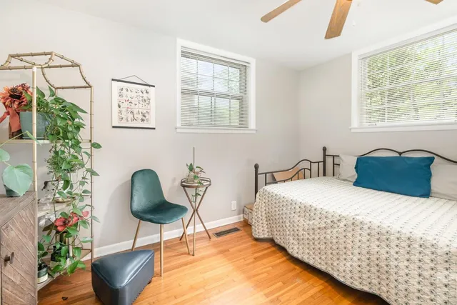a bedroom with a bed and a potted plant
