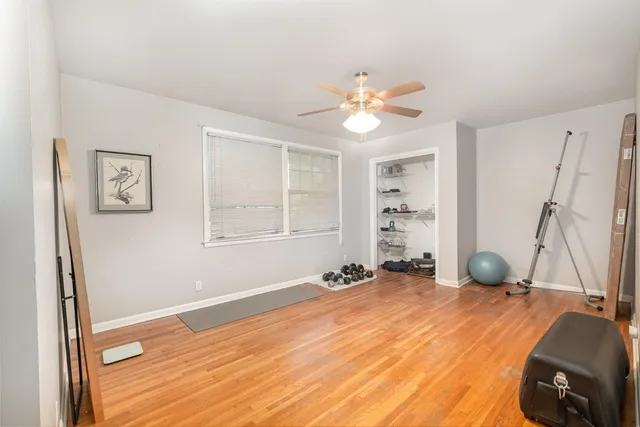 a view of a room with wooden floor and window