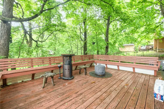 a view of outdoor sitting area with furniture and wooden floor