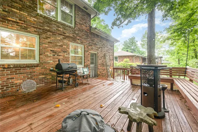 a view of a patio with table and chairs barbeque wooden floor and fence