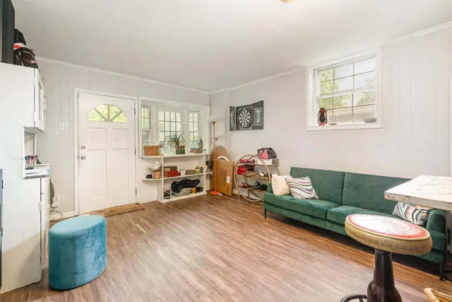 a living room with furniture and a wooden floor