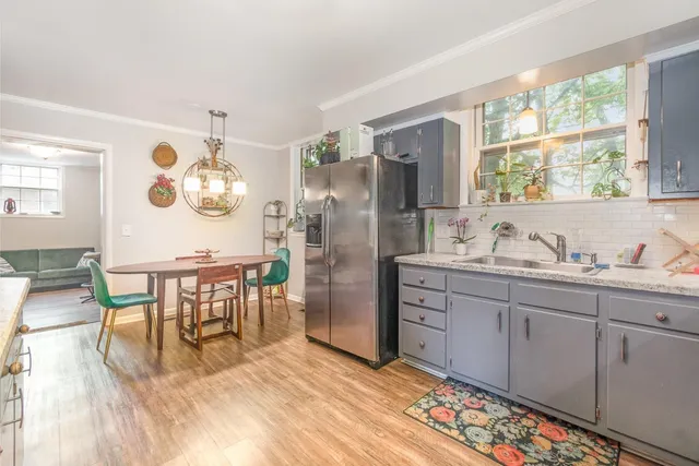 a kitchen with stainless steel appliances granite countertop a refrigerator and a stove top oven