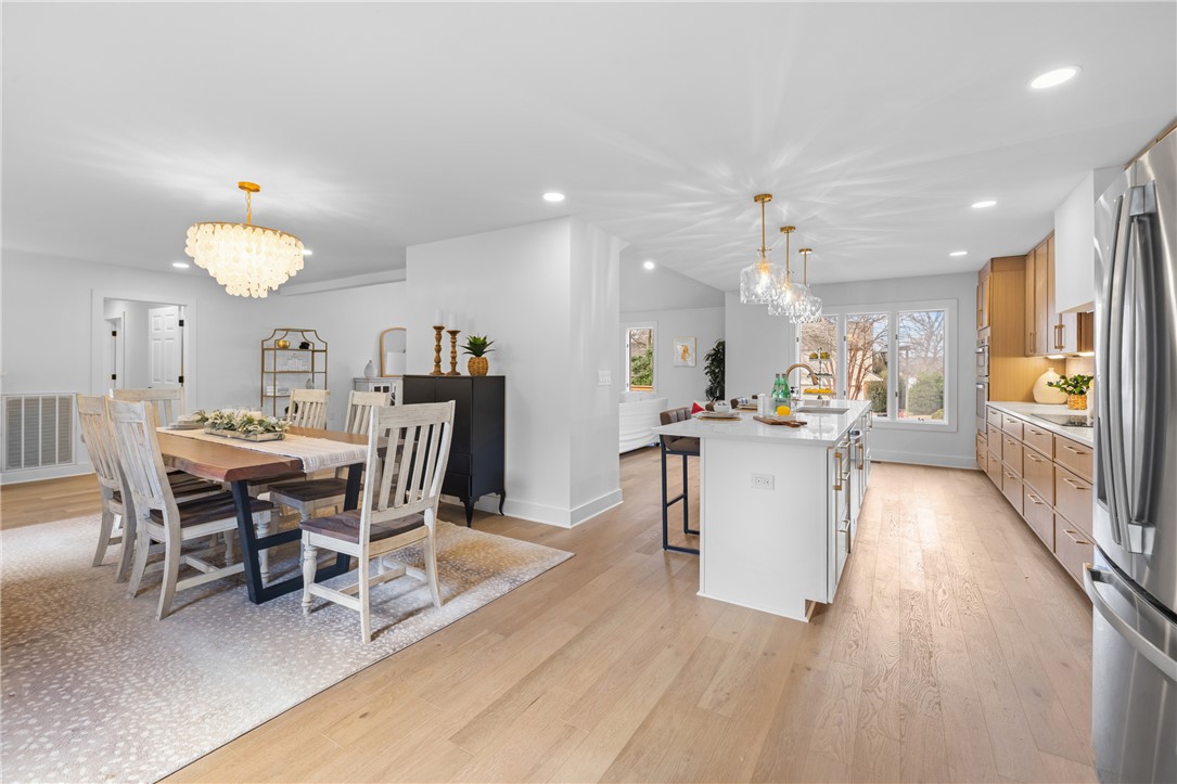 117 Riverpoint Drive Clemson, SC 29631 - Photo 21 of 47 An inviting open-concept space features hardwood floors, a bright dining area, and a functional kitchen island.