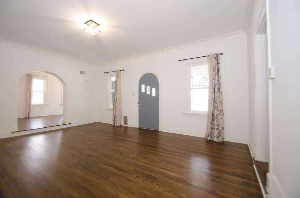 4572 Princeton Road Memphis, TN 38117 - Photo 6 of 24 Foyer entrance featuring arched walkways, dark wood-style floors, healthy amount of natural light, and ornamental molding
