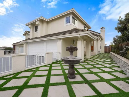 a front view of a house with a yard table and chairs