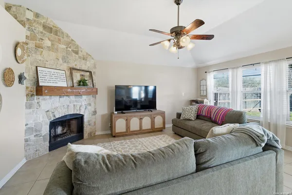 a living room with furniture a fireplace and a flat screen tv