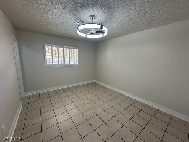 3322 South Pecos Road Las Vegas, NV 89121 - Photo 13 of 16 Durable tile flooring anchors this versatile space, illuminated by modern overhead lighting.