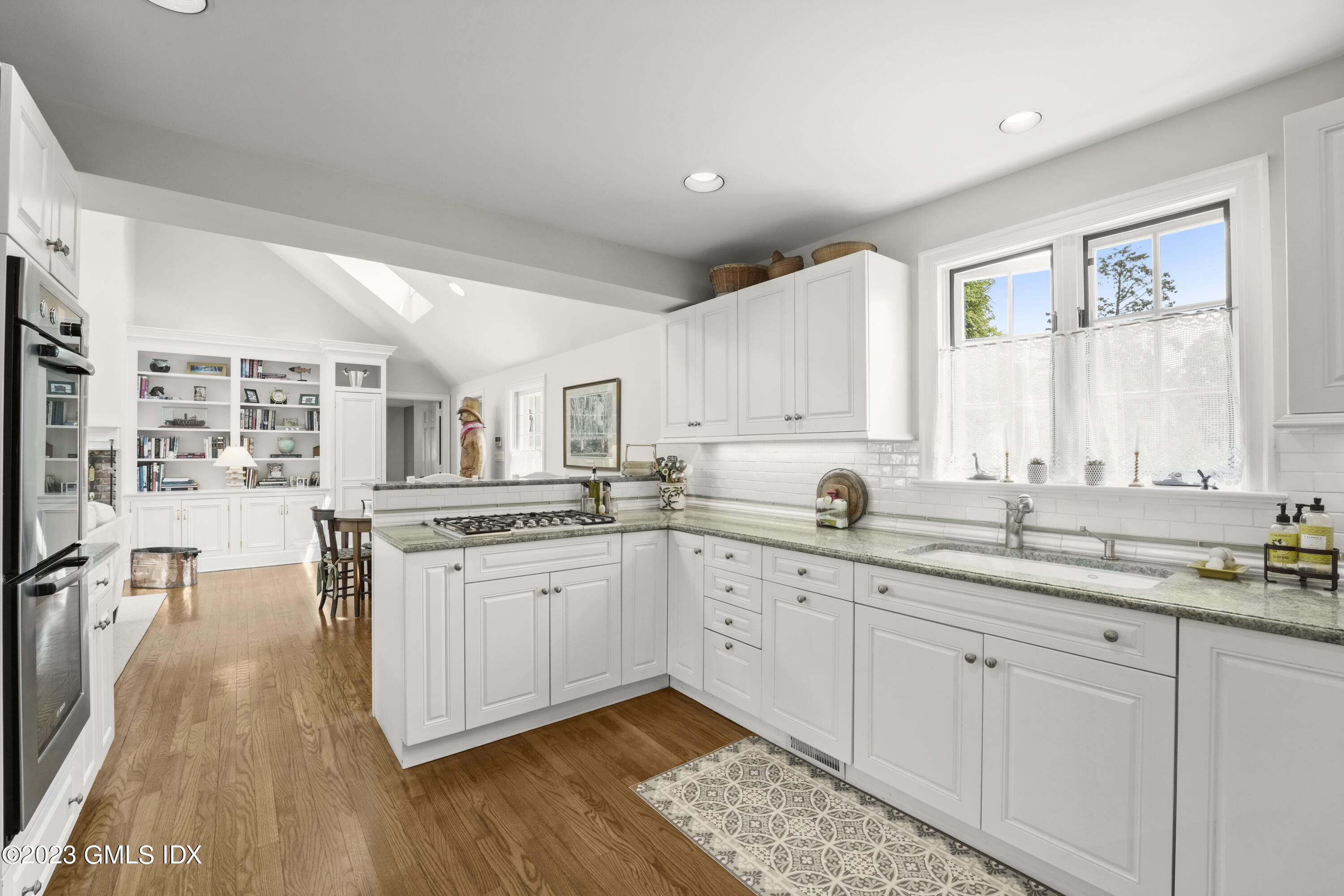 160 Stanwich Road Greenwich, CT 06830 - Photo 8 of 11 a open a kitchen with granite countertop a sink cabinets and wooden floor