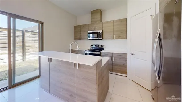 a kitchen with stainless steel appliances a refrigerator and a sink