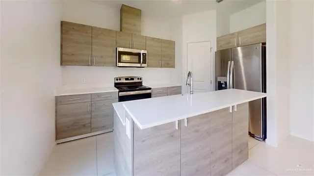 a kitchen with stainless steel appliances a refrigerator and a stove