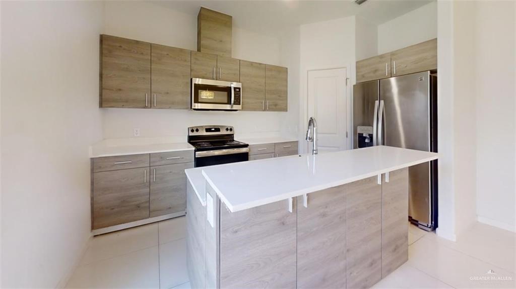 5608 Nightingale Avenue, Unit 2 Mission, TX 78573 - Photo 5 of 9 a kitchen with stainless steel appliances a refrigerator and a stove