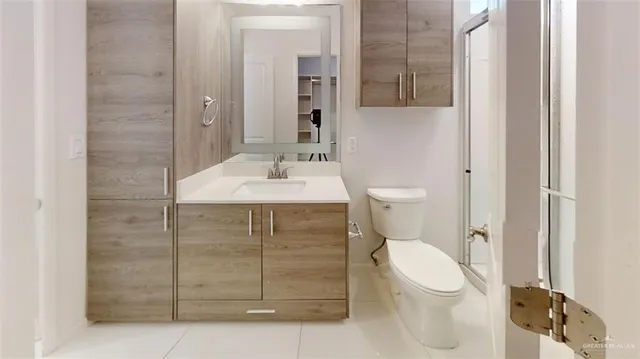 a bathroom with a toilet a sink and mirror