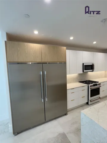 a kitchen with stainless steel appliances a refrigerator and a stove