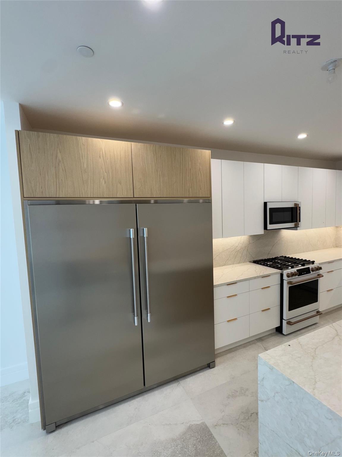 a kitchen with stainless steel appliances a refrigerator and a stove