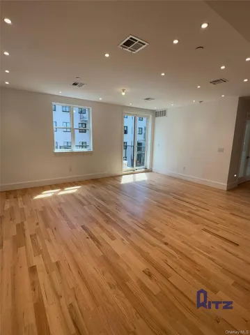 a view of kitchen with stainless steel appliances refrigerator sink and cabinets