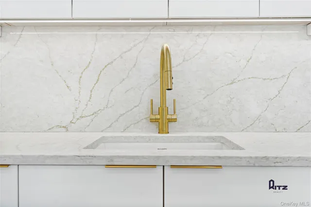 a kitchen with kitchen island a sink stainless steel appliances and cabinets