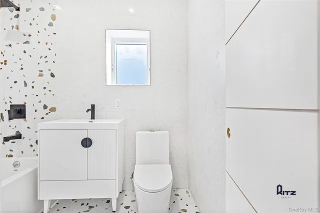 a white toilet sitting next to a shower curtain
