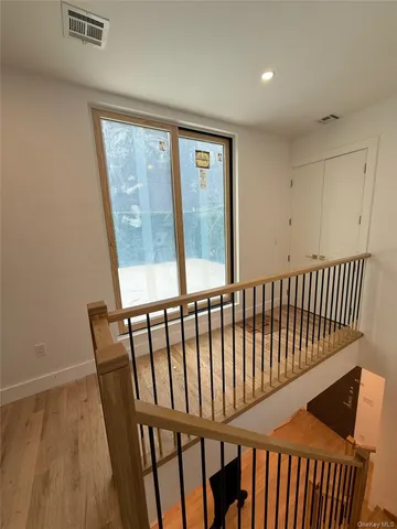 a view of hallway with a wooden floor