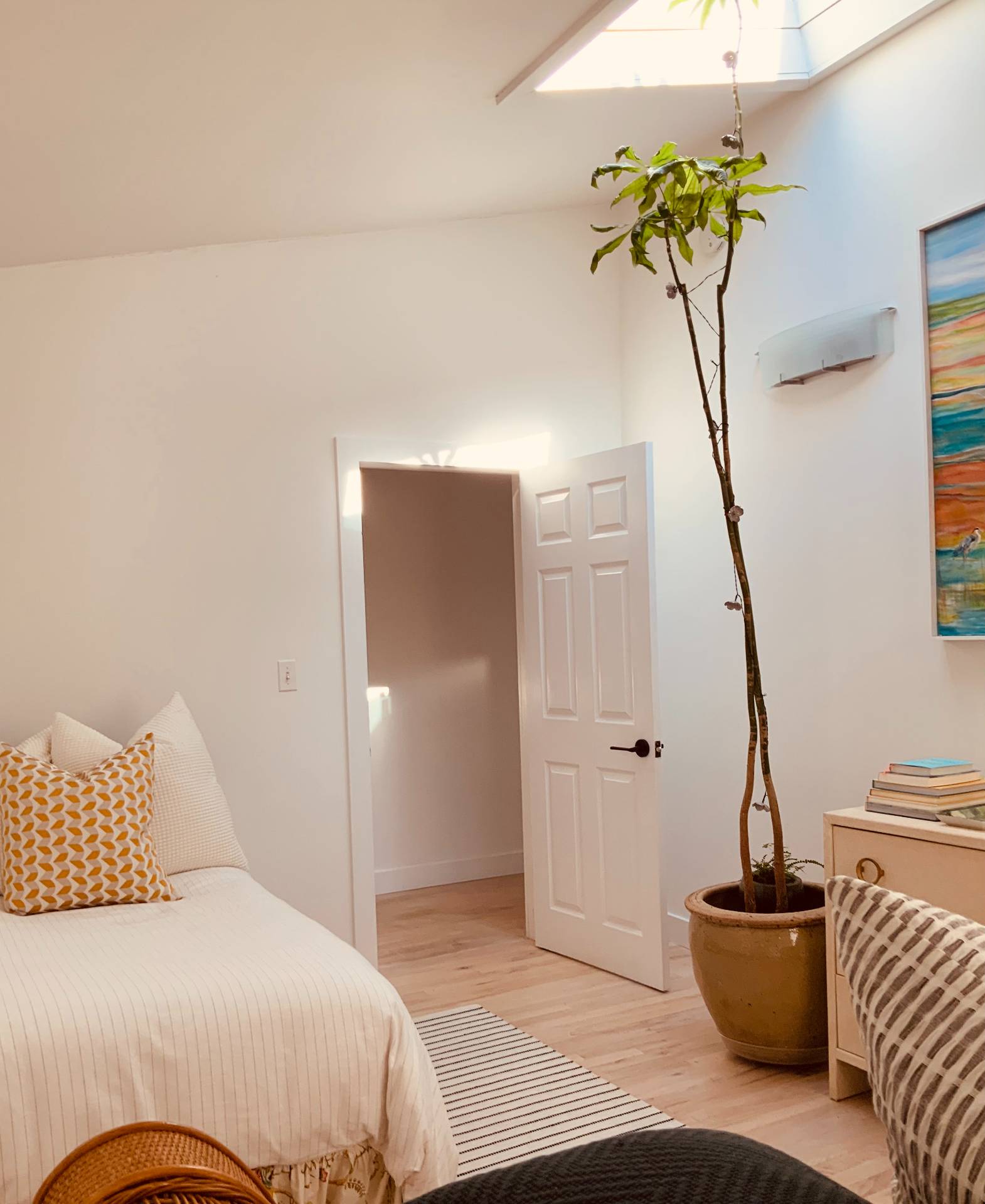 61 Rutland Road East Hampton, NY 11937 - Photo 13 of 19 a bedroom with a bed and a chandelier