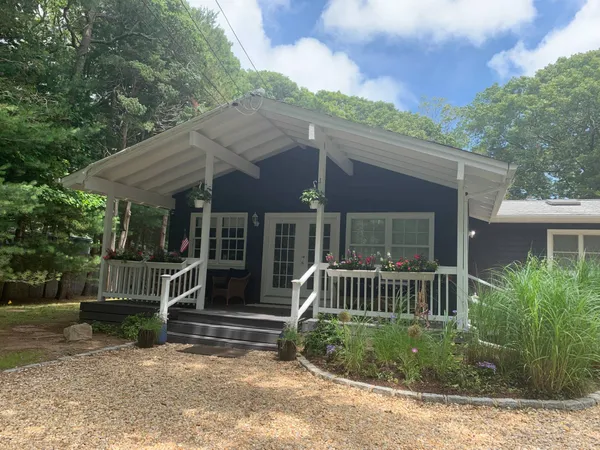 a front view of a house with a garden