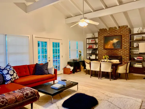 a living room with furniture a rug and a flat screen tv
