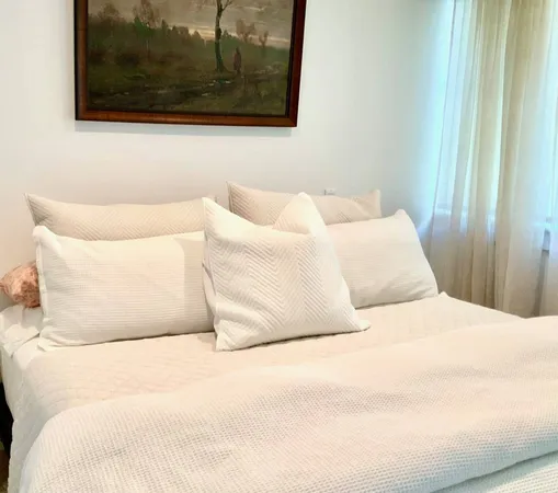 a large white bed in a white room