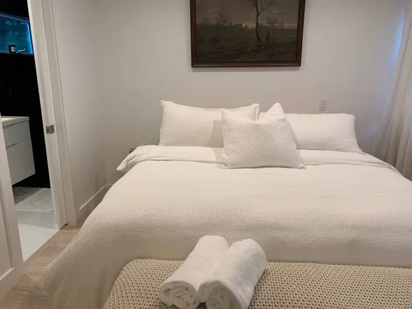 a bedroom with a bed and couch