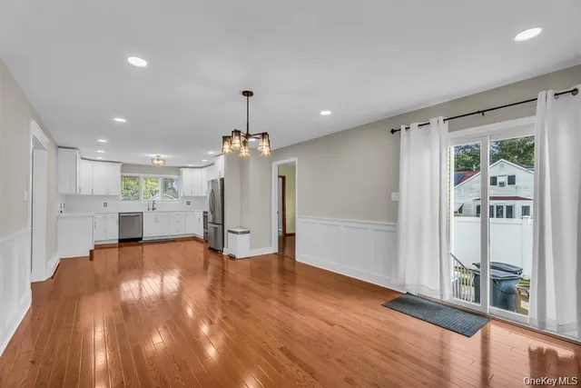a view of a living room and kitchen with hardwood floor
