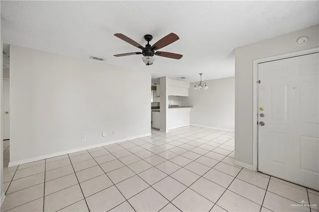a view of a kitchen with a sink and a refrigerator